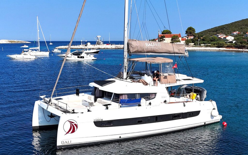 Luxury catamaran anchored in Premuda Island, Adriatic Sea—a top sailing destination for catamaran charter in Croatia. Safe anchorage, turquoise waters, and a historic stone village. Easily book your dream yacht charter using our yacht charter search engine for catamaran sailing holidays in Croatia.